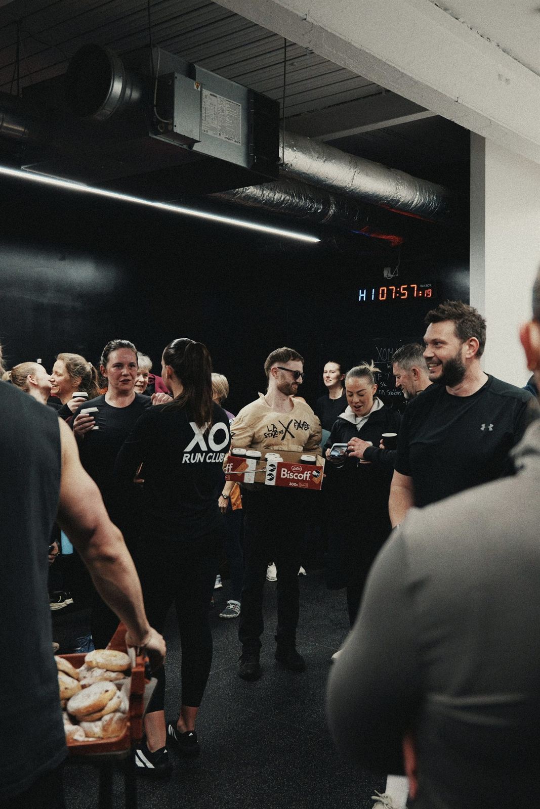 XO Fitness members chatting after a session with coffee